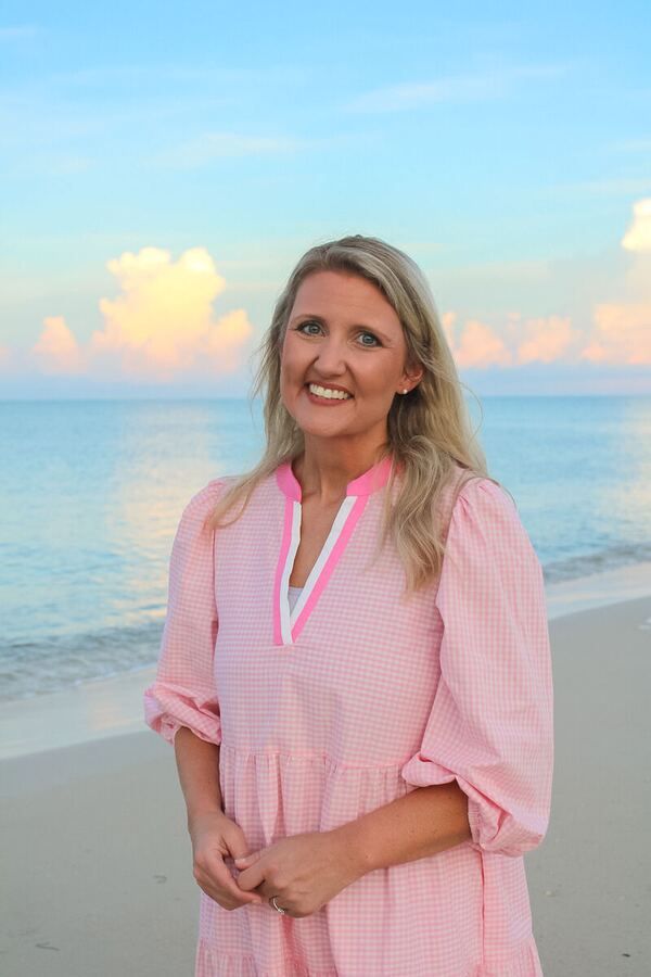 Woman in a sunset-colored dress on the beach